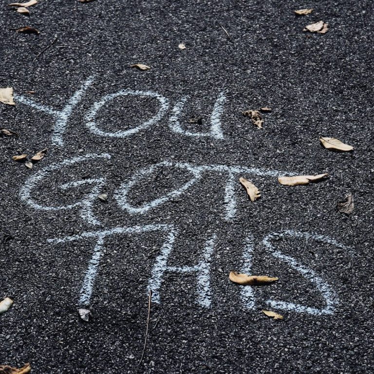 Auf dem Boden steht in großer Schrift: "YOU GOT THIS". Herbstliche Blätter liegen herum.
