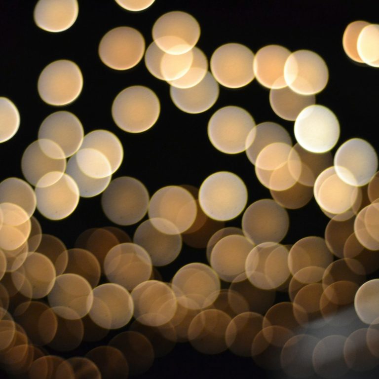 Farbenfrohe, spiralförmige Lichtmuster auf dunklem Hintergrund.